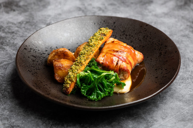 Roast breast free-range Caldecott farm turkey, sage and cranberry stuffing, rosemary roast potatoes, parsnip puree, pigs in blankets, buttered kale, roast turkey sauce